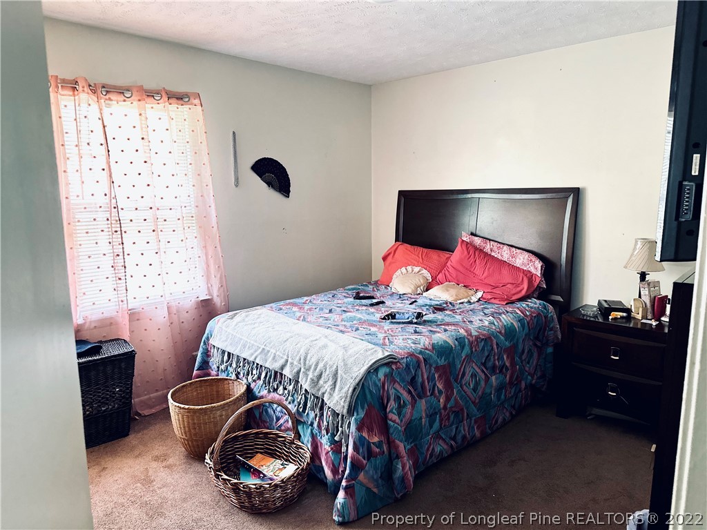 7405 Southgate Road Fayetteville, NC 28314 - Photo 12 of 16 a bedroom with a bed and a window