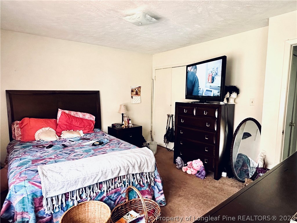 7405 Southgate Road Fayetteville, NC 28314 - Photo 14 of 16 a bedroom with a bed window and dresser