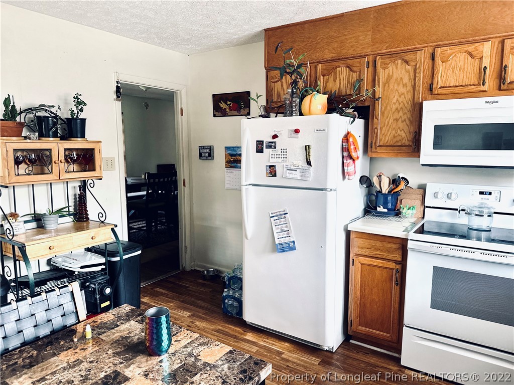 7405 Southgate Road Fayetteville, NC 28314 - Photo 7 of 16 a white refrigerator freezer sitting inside of a kitchen