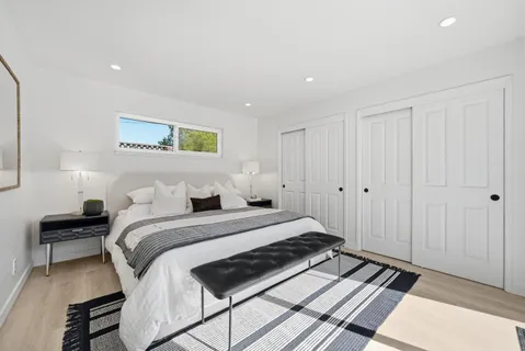 a bedroom with a large bed and a chandelier