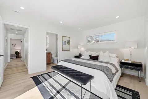 a bedroom with bed and a window