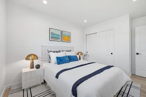 a bedroom with bed and a potted plant