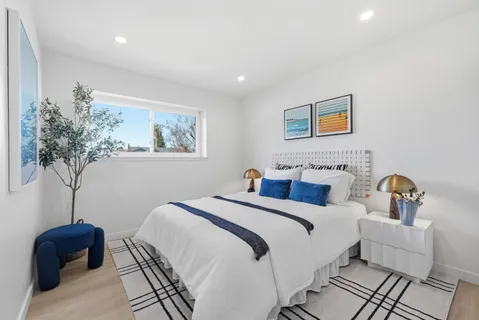 a bedroom with furniture and a potted plant