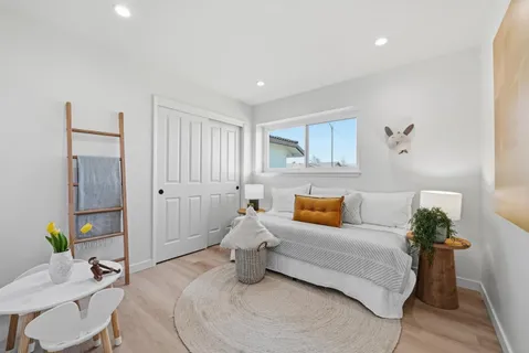 a bedroom with a bed and window