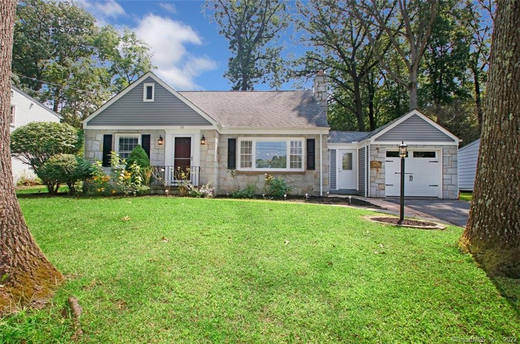 32 Madison Avenue Wallingford, CT 06492 - Photo 1 of 1 a front view of a house with a garden and yard