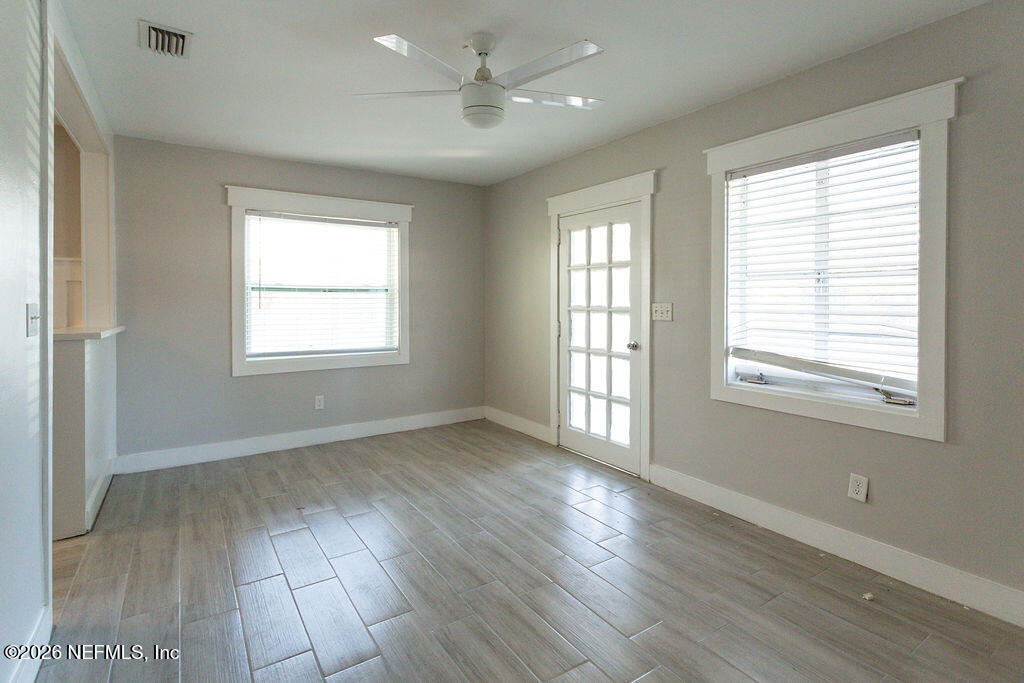 2533 Orchard Street Jacksonville, FL 32254 - Photo 12 of 13 a view of an empty room with wooden floor and a window