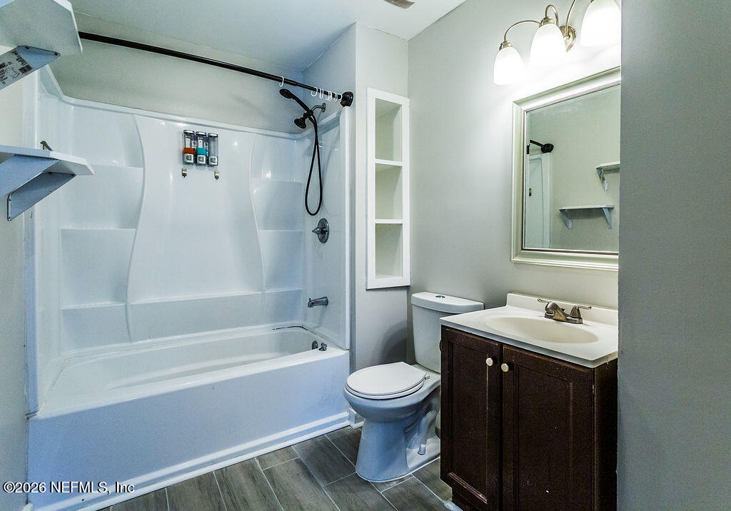 2533 Orchard Street Jacksonville, FL 32254 - Photo 7 of 13 a bathroom with a sink toilet and shower