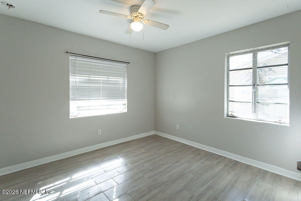 2533 Orchard Street Jacksonville, FL 32254 - Photo 10 of 13 a view of an empty room with wooden floor and a window