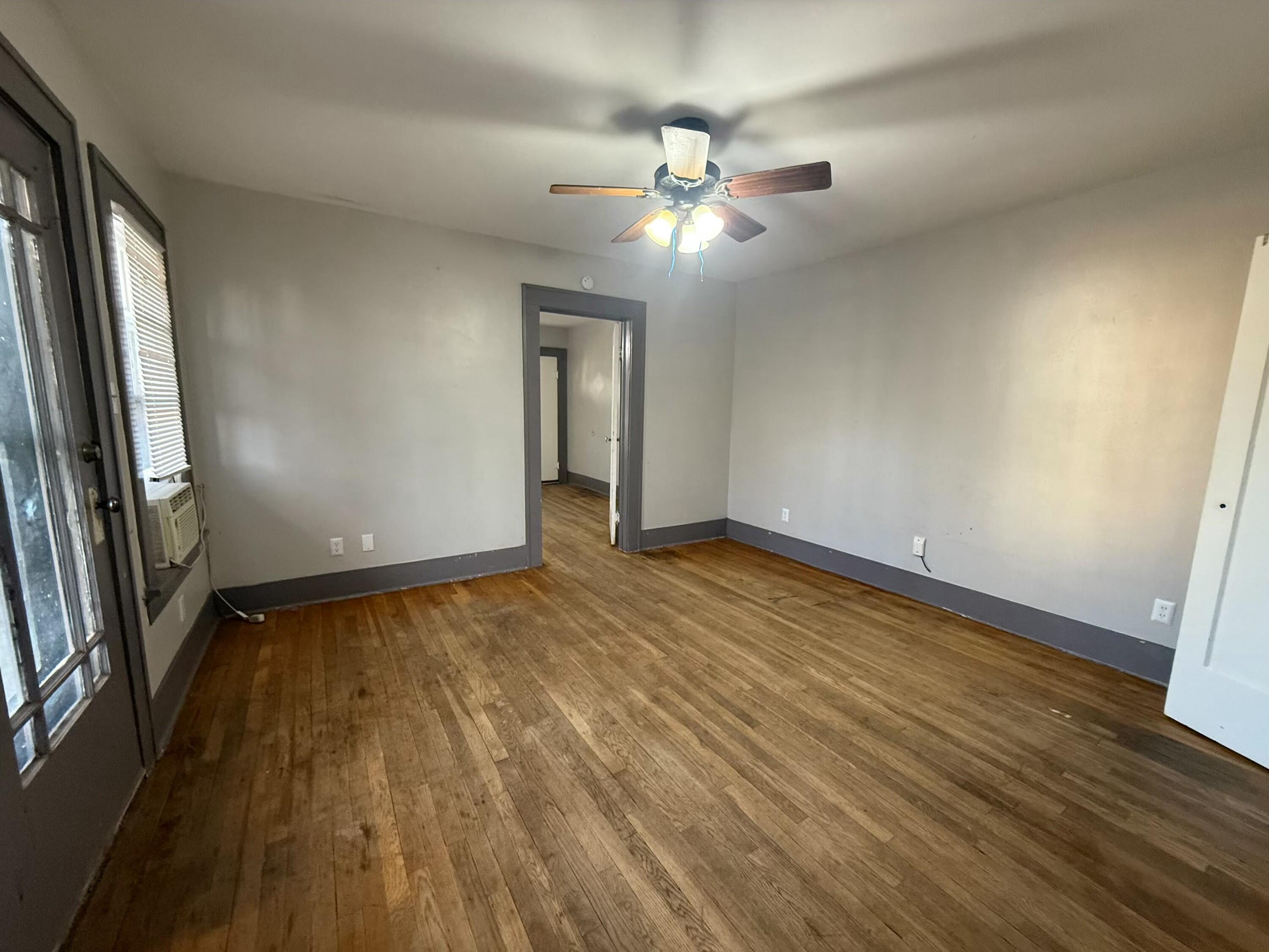 Package Package Property Lubbock, TX 79411 - Photo 70 of 71 a view of an empty room with wooden floor and a window