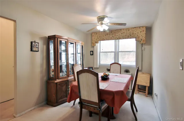 a view of a dining room with furniture and window