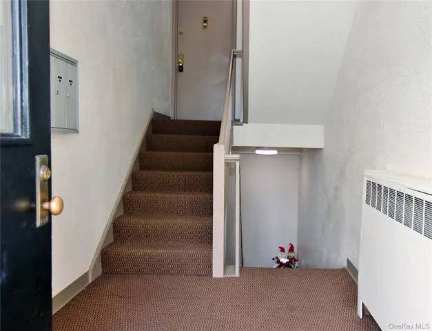a view of staircase with white walls