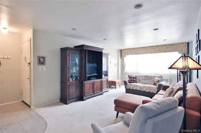 a living room with furniture ceiling fan and a window