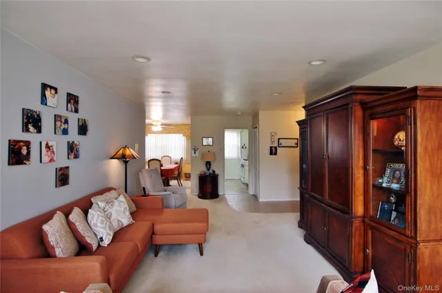 a living room with furniture cabinets and a window