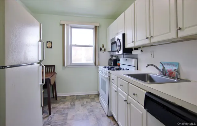 a kitchen with sink cabinets and window
