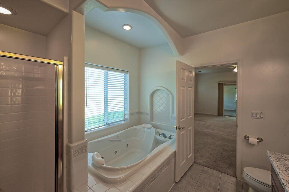 5747 Wilson Hill Road Manton, CA 96059 - Photo 14 of 31 a bathroom with a tub a sink and a large window