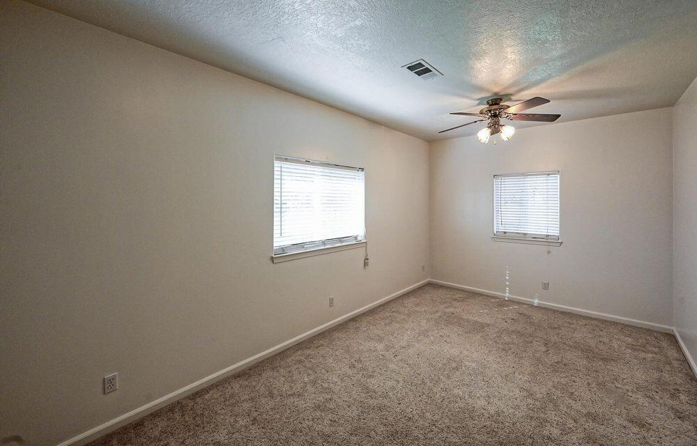 5747 Wilson Hill Road Manton, CA 96059 - Photo 18 of 31 an empty room with windows and fan