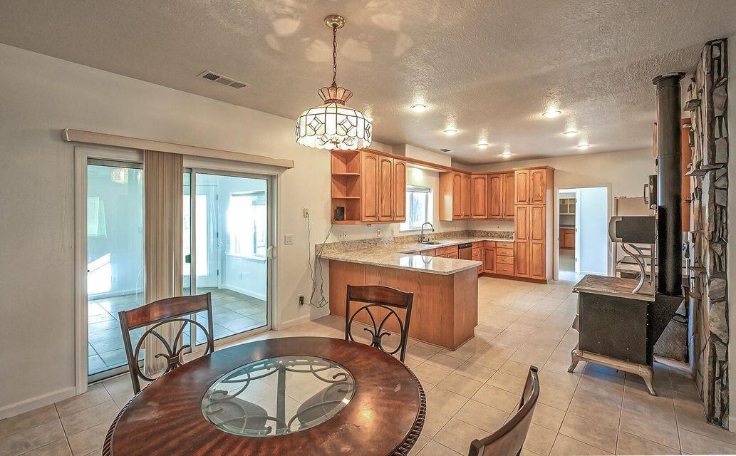 5747 Wilson Hill Road Manton, CA 96059 - Photo 7 of 31 a view of a dining room with furniture a chandelier and wooden floor