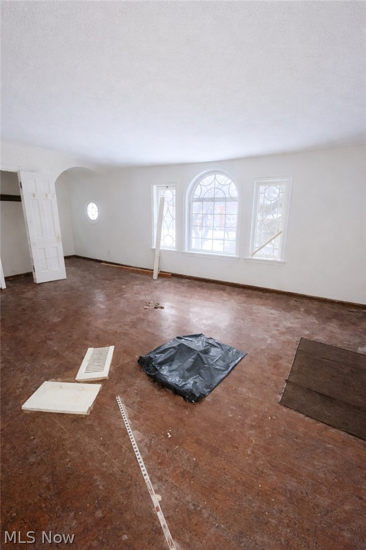 3575 Gridley Road Shaker Heights, OH 44122 - Photo 19 of 47 Unfurnished living room with arched walkways and baseboards
