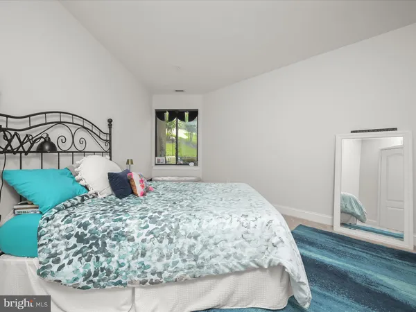 a view of a bedroom with wooden floor