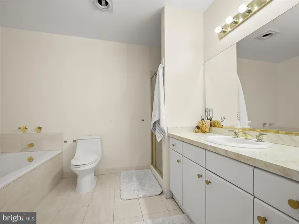 a view of bathroom with a toilet sink and mirror