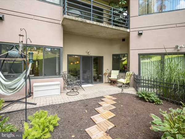a view of a patio with a table and chairs