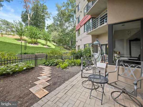 a view of a patio with table and chairs and potted plants