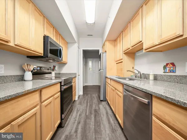 a kitchen with stainless steel appliances granite countertop a sink and cabinets