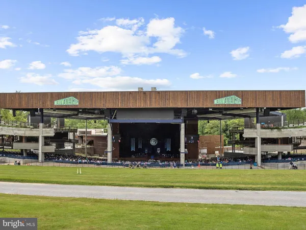 a view of a big room with a big yard and large trees