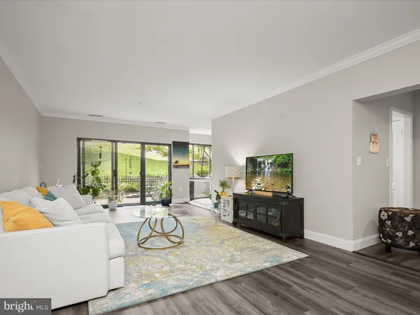 a living room with furniture large window and flat screen tv