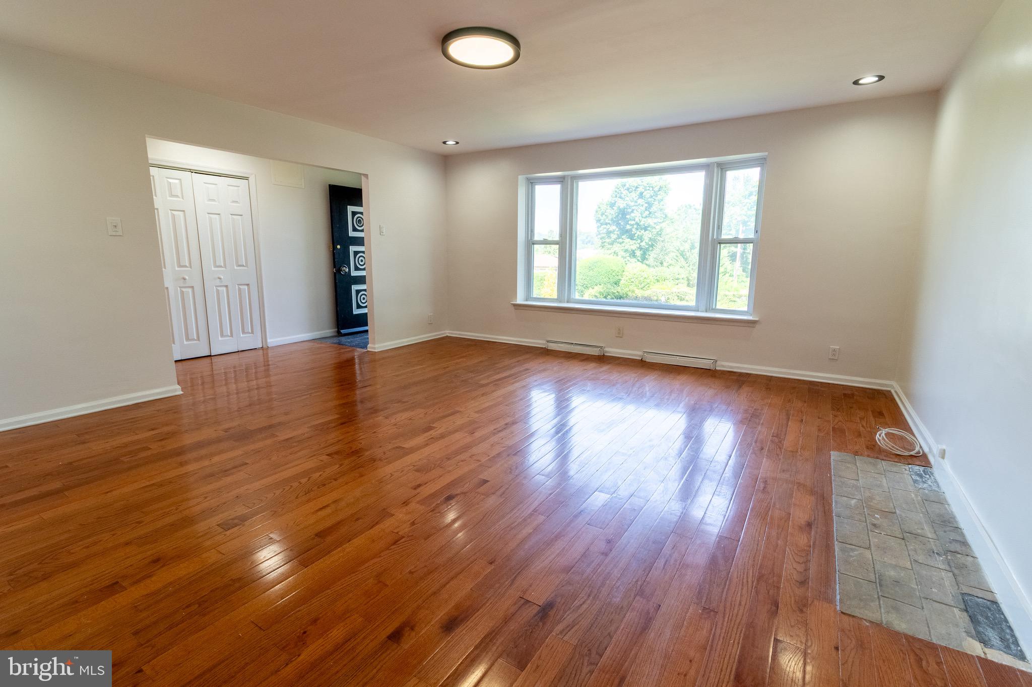 1545 Shoemaker Road Abington, PA 19001 - Photo 13 of 32 an empty room with wooden floor and windows
