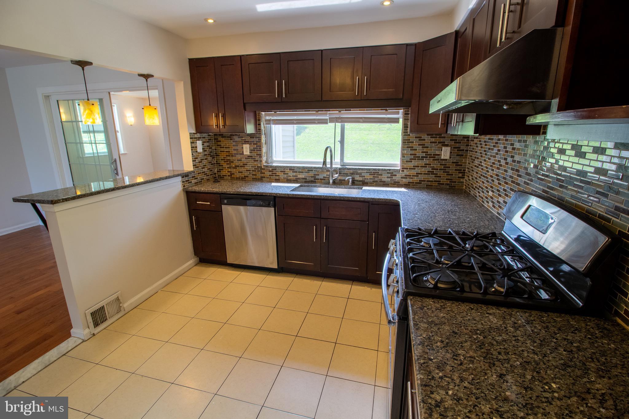 1545 Shoemaker Road Abington, PA 19001 - Photo 16 of 32 a kitchen with stainless steel appliances granite countertop a stove a sink and a microwave