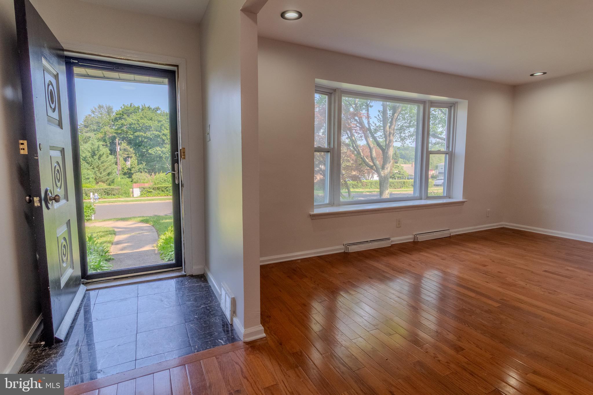 1545 Shoemaker Road Abington, PA 19001 - Photo 2 of 32 an empty room with wooden floor and windows
