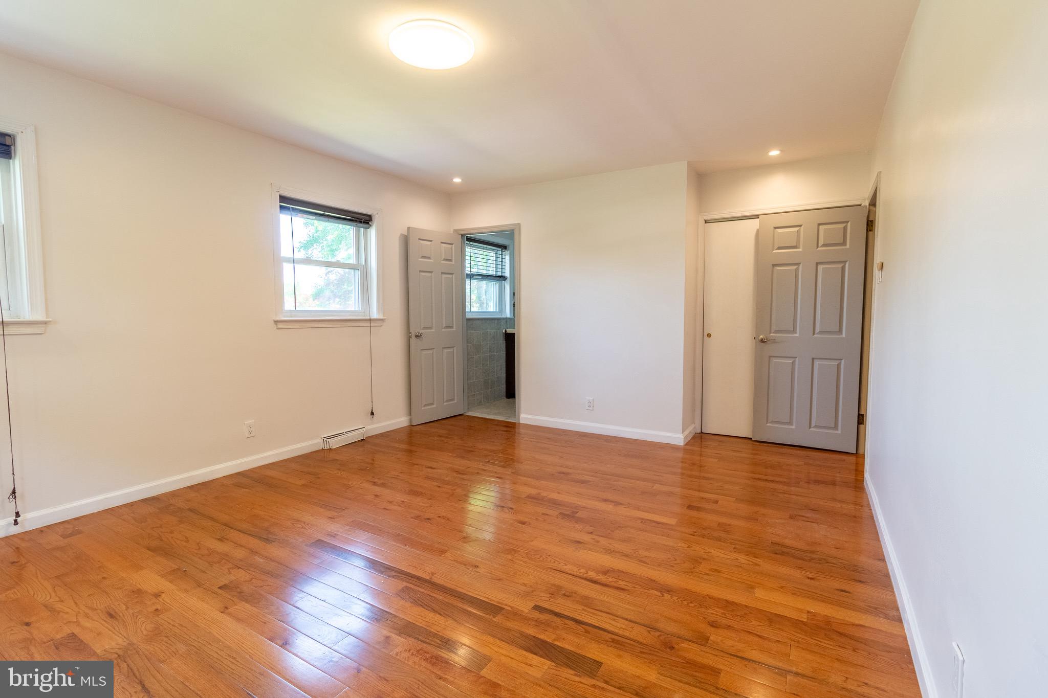 1545 Shoemaker Road Abington, PA 19001 - Photo 4 of 32 a view of an empty room with wooden floor and a window