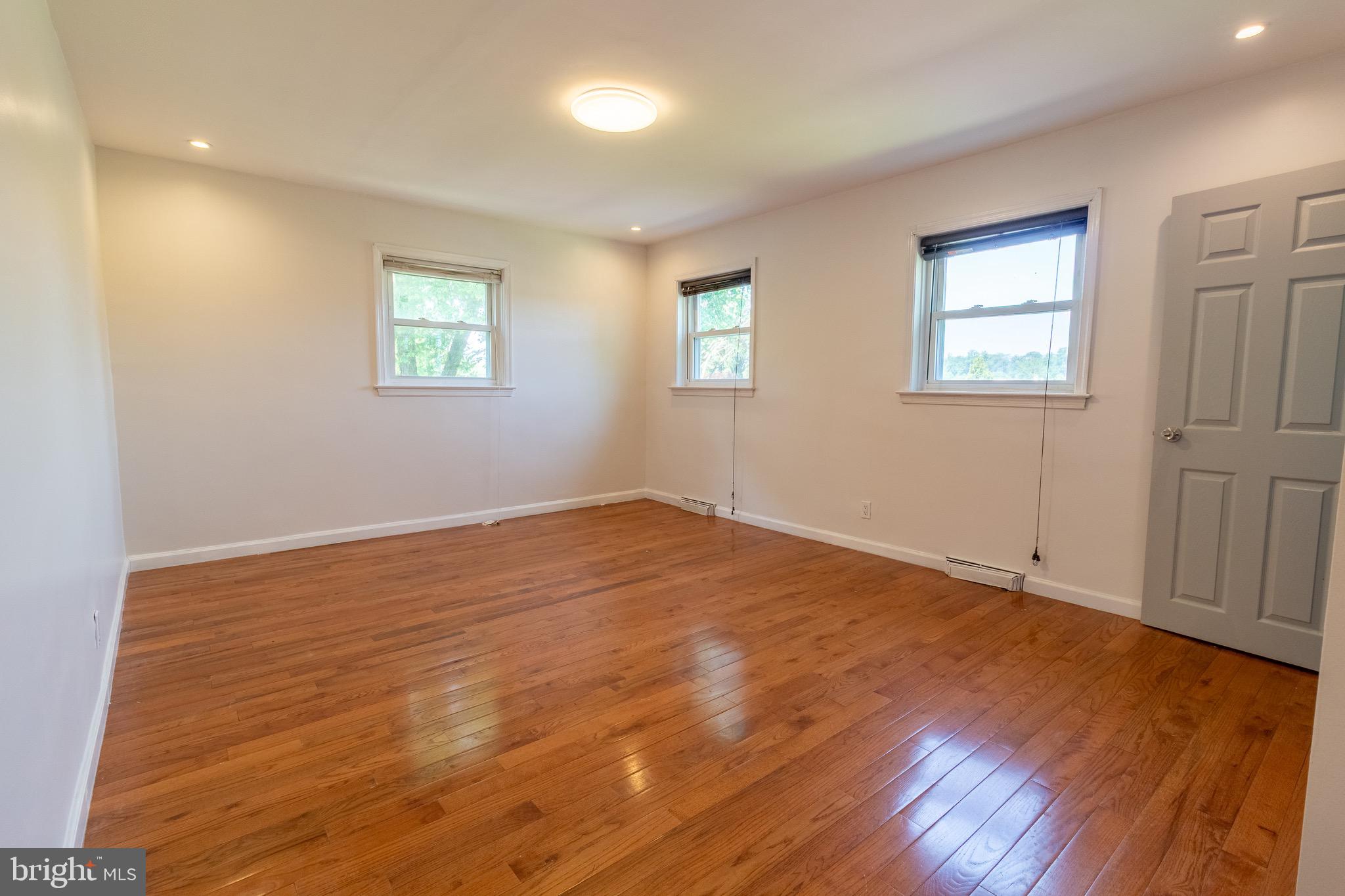 1545 Shoemaker Road Abington, PA 19001 - Photo 5 of 32 a view of empty room with wooden floor and fan