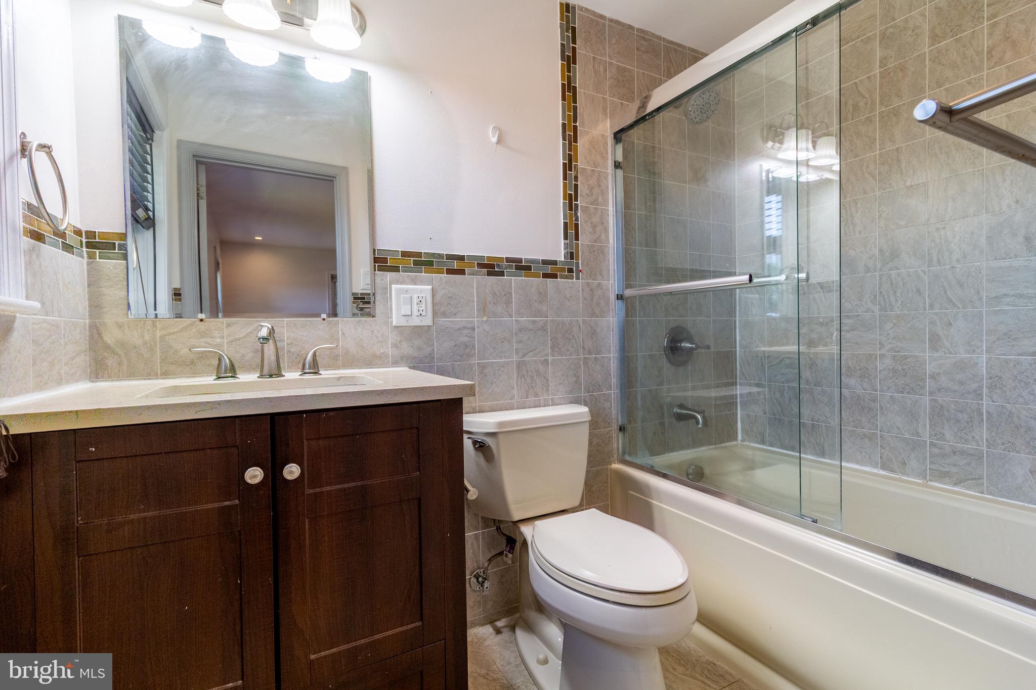 1545 Shoemaker Road Abington, PA 19001 - Photo 6 of 32 a bathroom with a sink vanity mirror and toilet