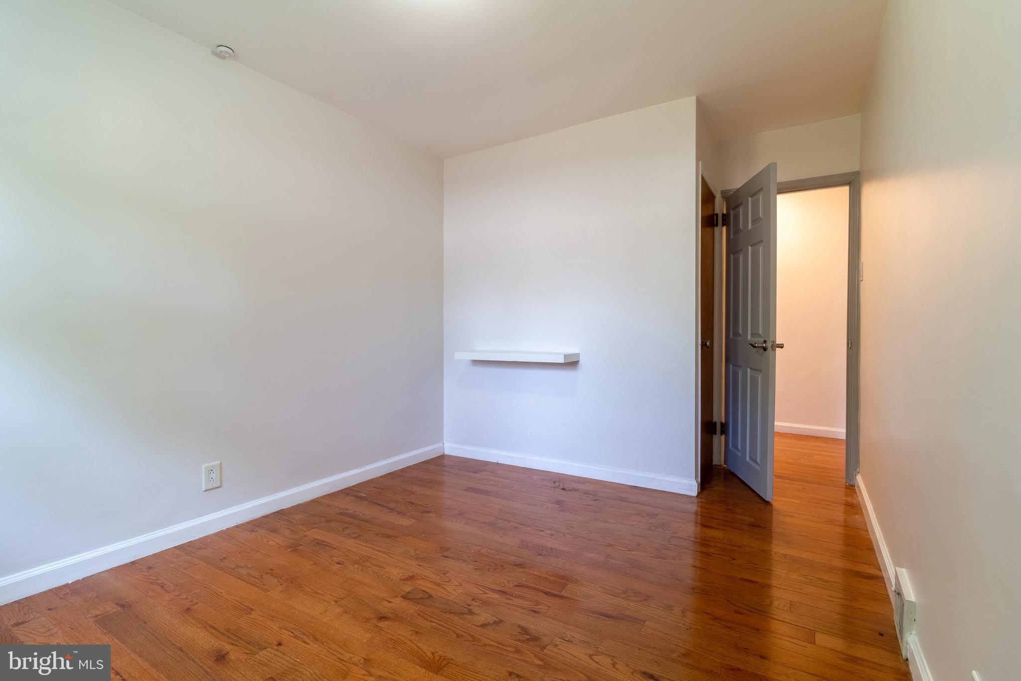 1545 Shoemaker Road Abington, PA 19001 - Photo 7 of 32 an empty room with wooden floor and windows