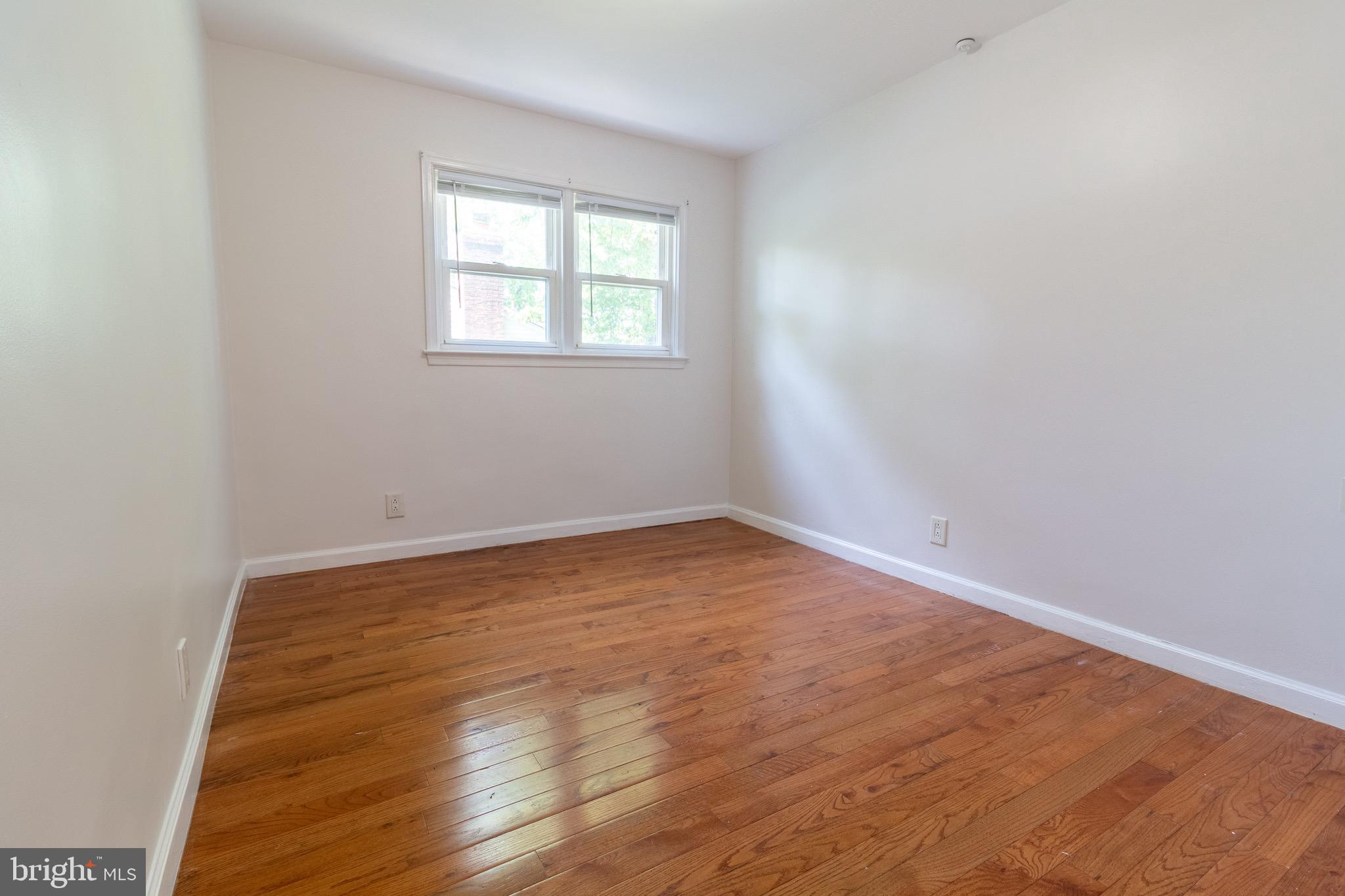 1545 Shoemaker Road Abington, PA 19001 - Photo 8 of 32 an empty room with wooden floor and windows