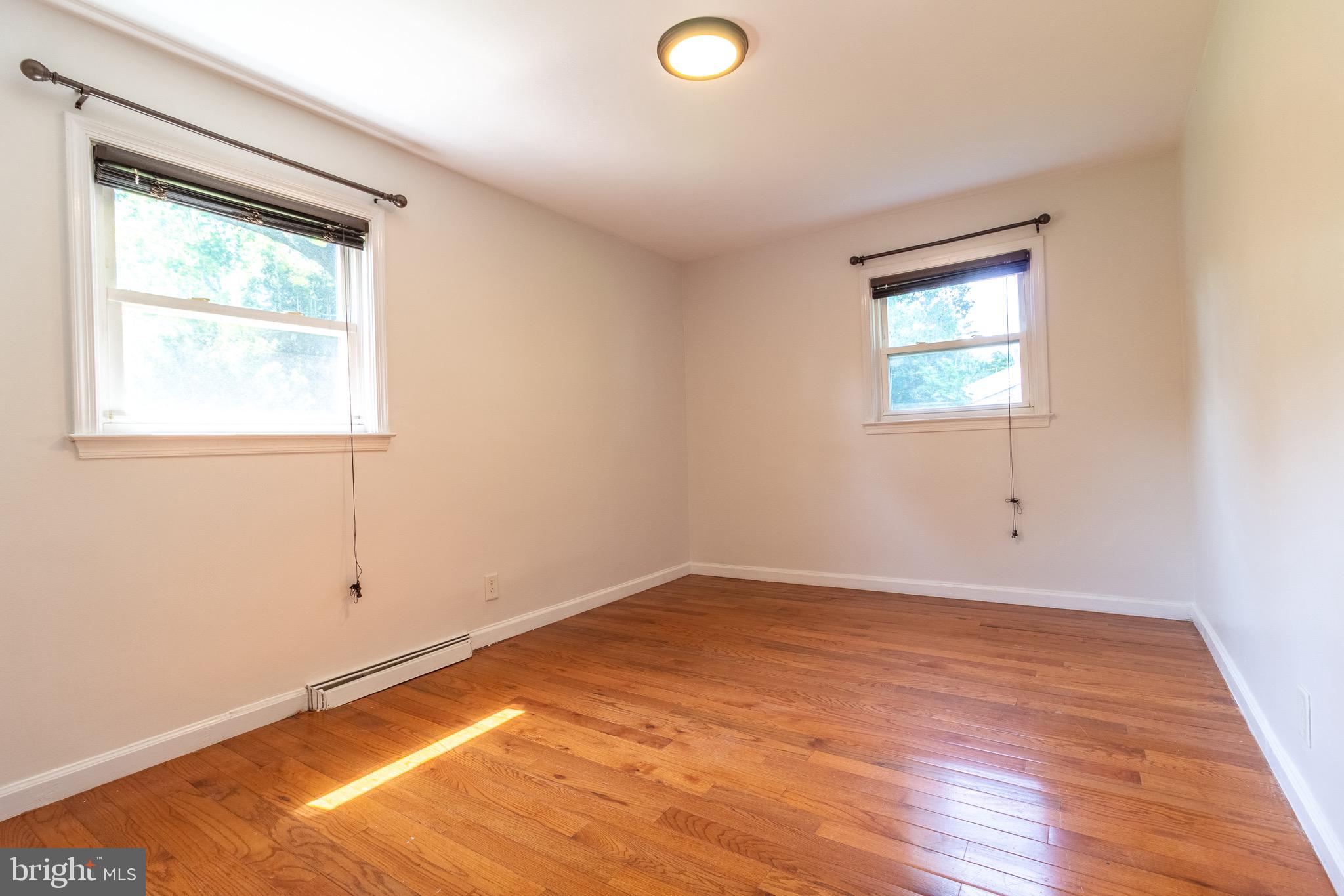 1545 Shoemaker Road Abington, PA 19001 - Photo 10 of 32 an empty room with wooden floor and windows