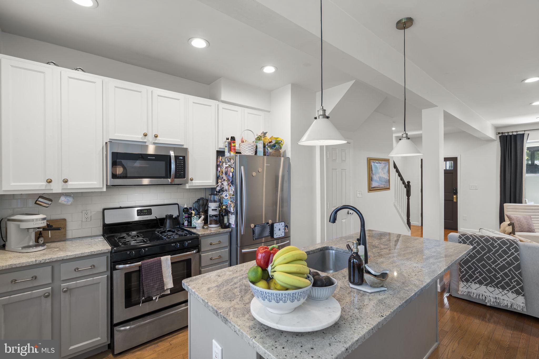 1712 M Street Northeast Washington, DC 20002 - Photo 1 of 38 a kitchen with stainless steel appliances granite countertop a sink stove and refrigerator