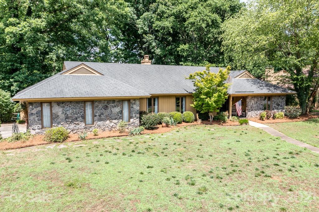 4401 Rounding Run Road Charlotte, NC 28277 - Photo 4 of 31 a front view of a house with a yard and seating space