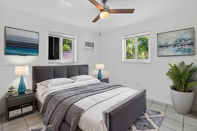 a bedroom with a bed and a potted plant