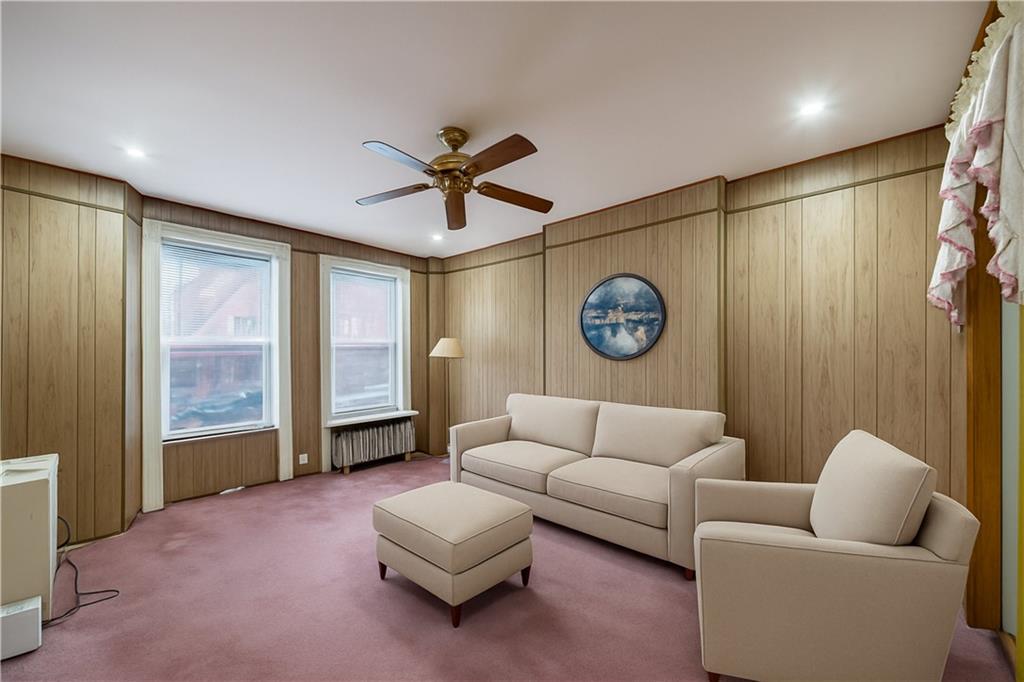 335 Bay Ridge Parkway Brooklyn, NY 11209 - Photo 4 of 15 a living room with furniture a clock and a window