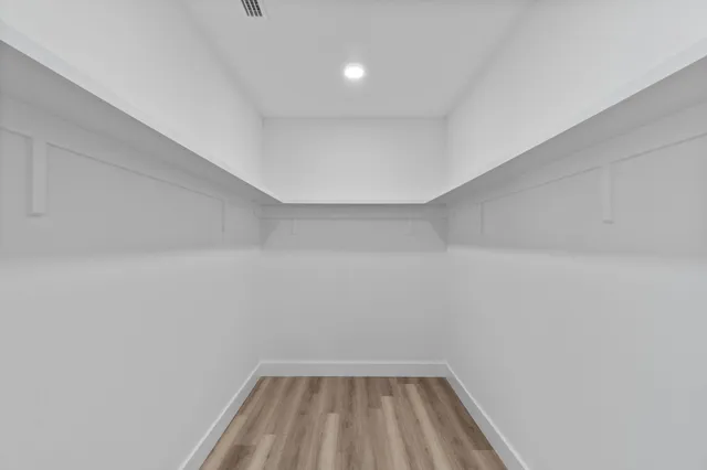 a white toilet sitting next to a shower