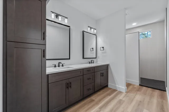 an empty room with wooden floor and ceiling fan