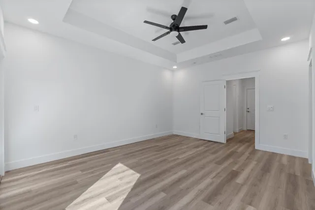 a view of a hallway with wooden floor