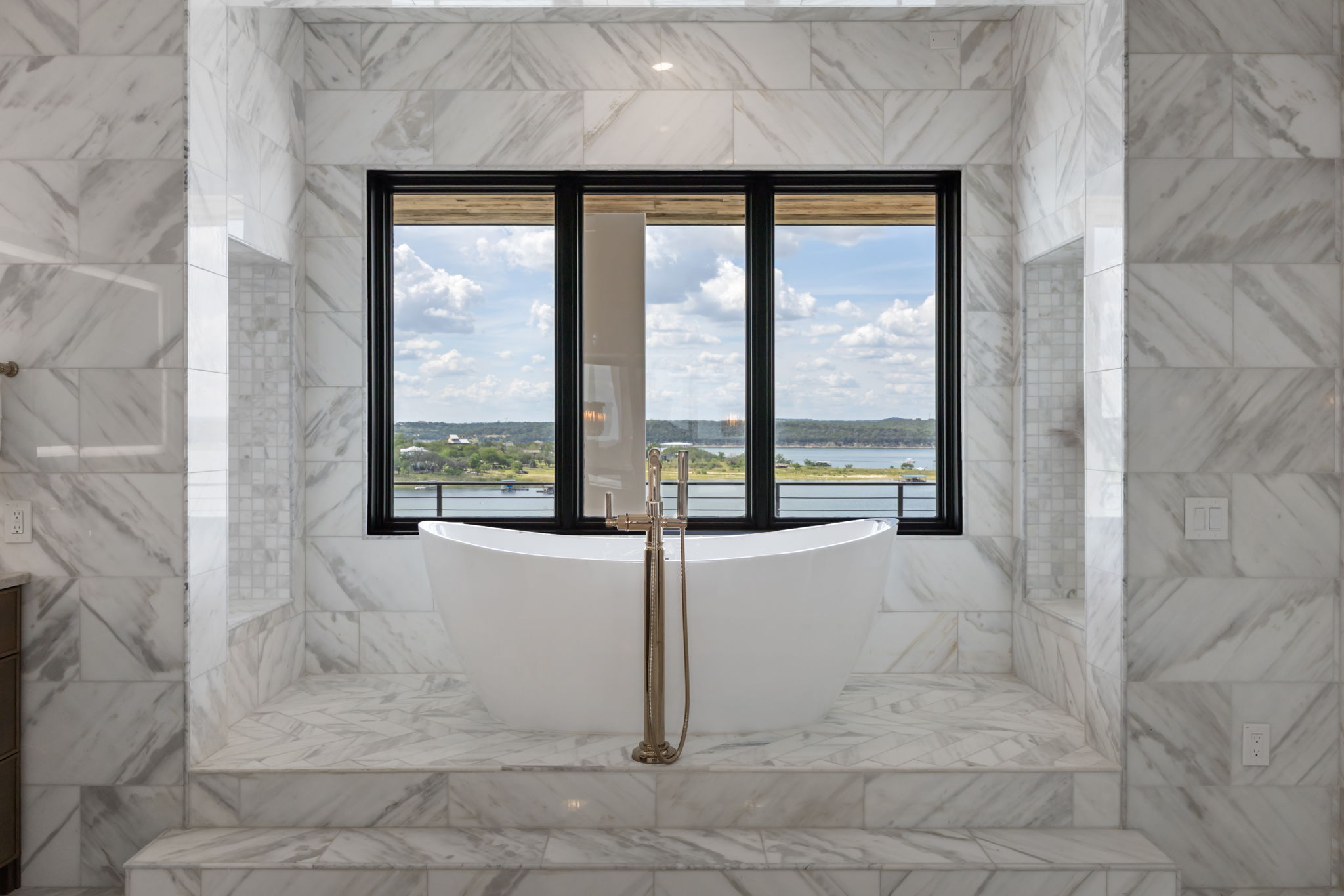 1496 Buffalo Gap Road Lakeway, TX 78734 - Photo 22 of 37 Indulge in a relaxing soak with sweeping lake views from this lavish primary bathroom.