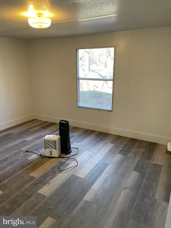 a room with a window and a fireplace