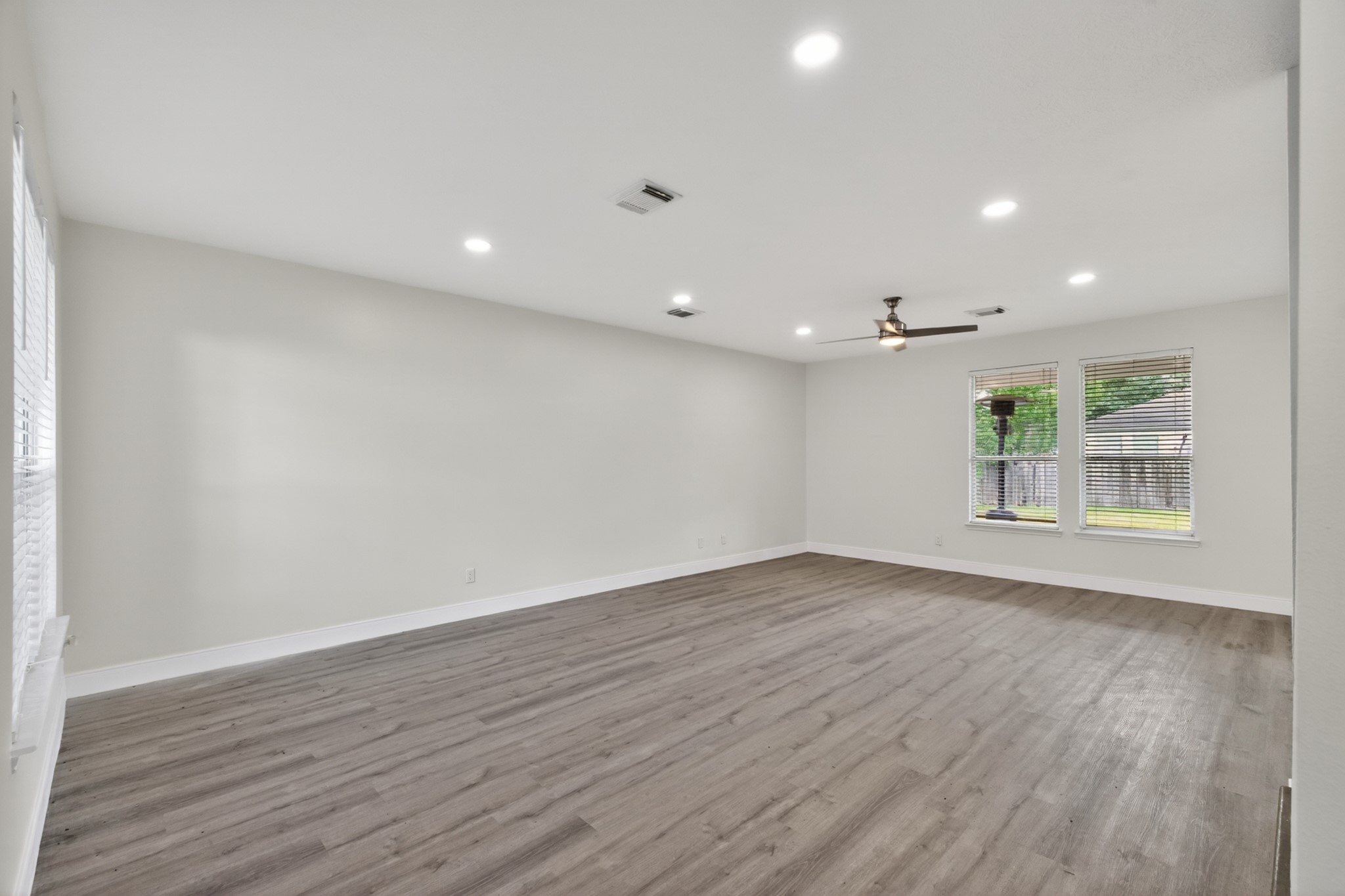 918 Ivycroft Lane Spring, TX 77373 - Photo 5 of 33 a view of an empty room with wooden floor and a window