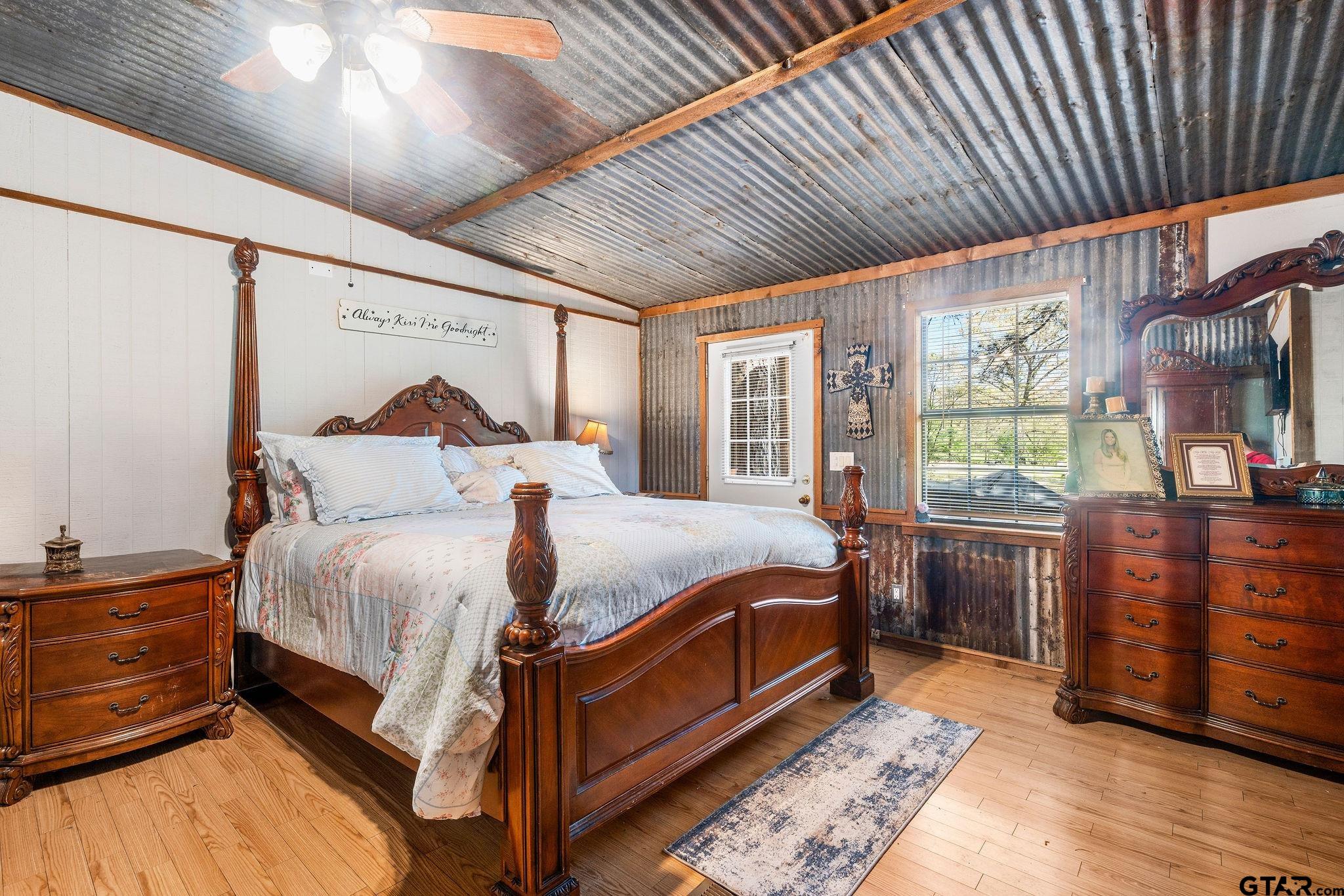 4550 Crabapple Road Gilmer, TX 75645 - Photo 5 of 33 a bedroom with a bed next to a window with outer view
