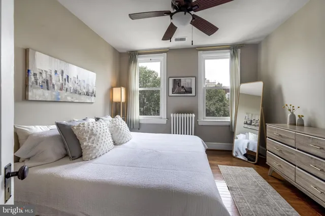 a bedroom with a large bed and a chandelier